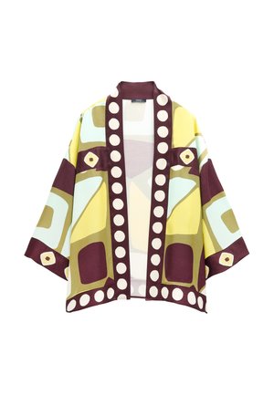 Krótka kurtka z szerokimi rękawami, ozdobiona geometrycznymi wzorami w kolorach żółtym, zielonym, burgundowym i kremowym, z dużymi kremowymi kropkami na bordowych brzegach.