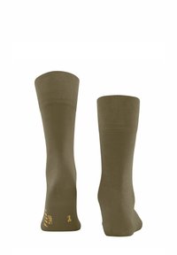 Chaussettes vert olive avec texture côtelée et bords renforcés, arborant un logo imprimé en or sur le côté. Ajustement confortable pour un port quotidien.