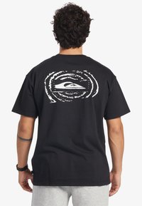 Black cotton t-shirt with a circular white graphic featuring a wave design on the back. Short sleeves and a relaxed fit.