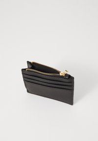 Black leather wallet with gold zipper, featuring multiple card slots on one side and a textured finish. Compact rectangular design.