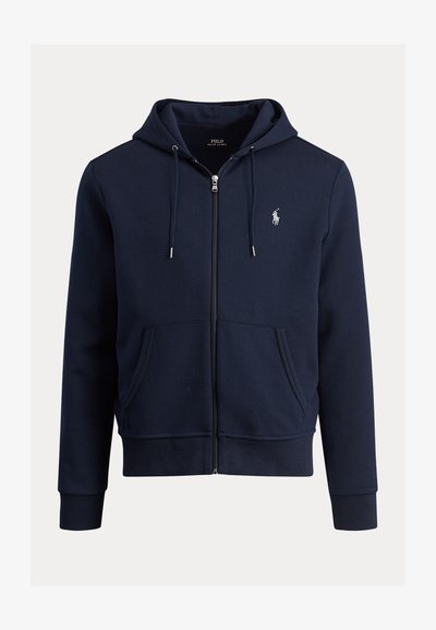 Tmavě modrá mikina na zip z měkké látky, s přední kapsou, kapucí na stažení a vyšívaným logem na levé straně hrudi.