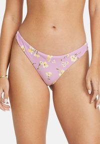 Purple bikini bottom with yellow floral pattern, ribbed texture, and a low-rise design. Features side ruching for added detail.