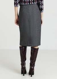 Grauer Bleistiftrock aus texturiertem Stoff, knielang, kombiniert mit glänzenden bordeauxfarbigen High-Heels mit Schnallen am Knöchel.