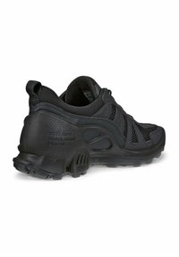 Svart atletisk sko med en ovandel i nät, vadderad krage och en mönstrad gummisula med multidirektionella greppspik.