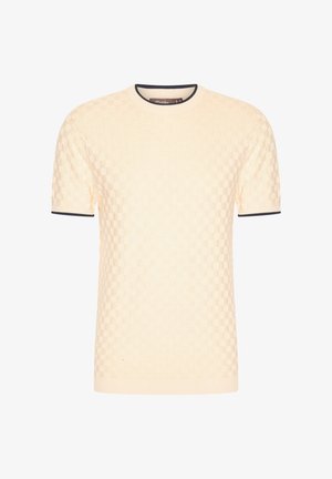 Korte mouwen creme trui met een gestructureerd geruit patroon, ronde halslijn en marineblauwe accenten op de manchetten en de kraag.