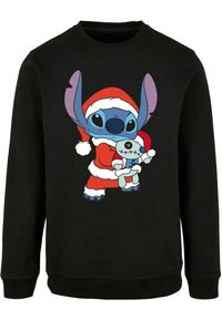 Felpa nera con un personaggio dei cartoni animati in un outfit da Babbo Natale, con grandi orecchie blu e che tiene in mano un piccolo giocattolo con un vestito simile.