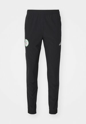 Pantaloni sportivi neri con vita elastica, tasche con zip, gambe affusolate e un patch circolare con logo sulla coscia sinistra.