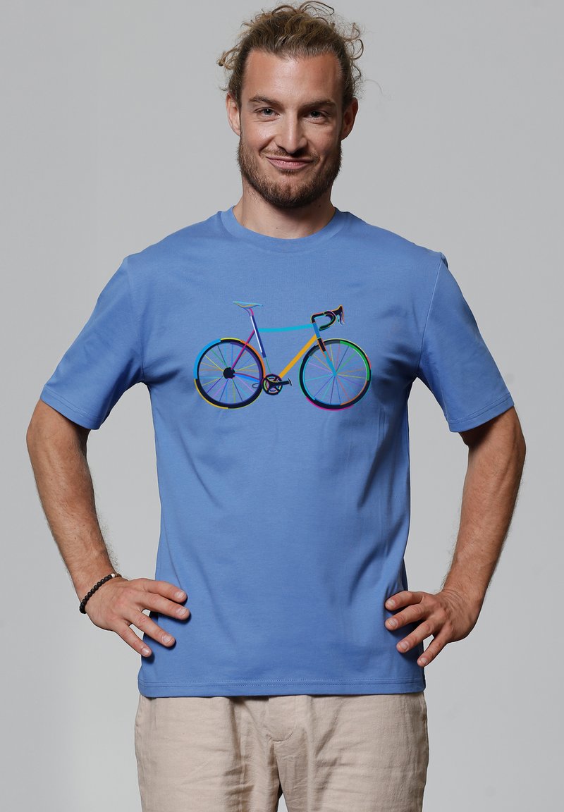  Lichtblauwe katoenen t-shirt met een multikleurige fietsafbeelding op de voorkant. Korte mouwen en een ronde halslijn.