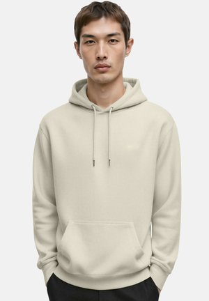 Felpa con cappuccio color crema in tessuto morbido, con tasca a marsupio frontale, cappuccio con coulisse e marchio discreto nella parte superiore del petto.