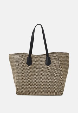Borsa a tracolla intrecciata in nero e beige con motivo geometrico, dotata di due manici in pelle nera e una forma rettangolare spaziosa.