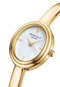 Goldfarbene Uhr mit rundem Gehäuse, Zifferblatt aus weißem Perlmutt und minimalistischen Stundenmarkierungen. Enthält eine strukturierte Krone und ein glattes Armband.