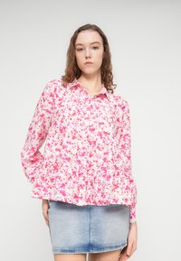 Αέρινο πουκάμισο με κουμπιά, με ροζ και κόκκινο λουλουδάτο σχέδιο σε λευκό φόντο, κατασκευασμένο από ελαφρύ ύφασμα. Μακριά μανίκια με μανσέτες που κλείνουν με κουμπιά.