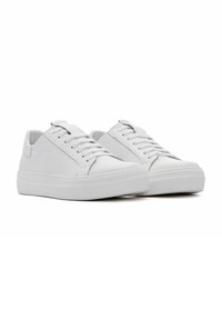 White leather sneakers featuring a smooth texture, lace-up design, and a thick rubber sole with a textured tread pattern.