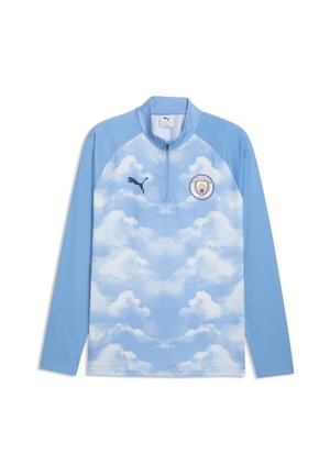 Lyseblå langærmet sportstop med hvidt sky-design, halv lynlås krave, Puma-logo på højre bryst og Manchester City-emblem på venstre bryst.