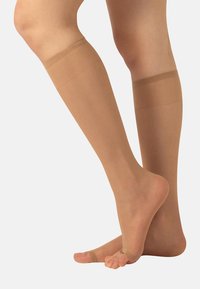 Beżowe rajstopy do kolan wykonane z przejrzystego materiału, charakteryzujące się gładką fakturą i elastycznymi paskami u góry dla pewnego dopasowania.