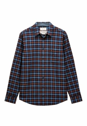 Brūna un zila rūtainā krekla ar garām piedurknēm, pogām pie apakšmalas, krūšu kabatu un izliekta apakšmalu. Izgatavots no mīksta auduma.