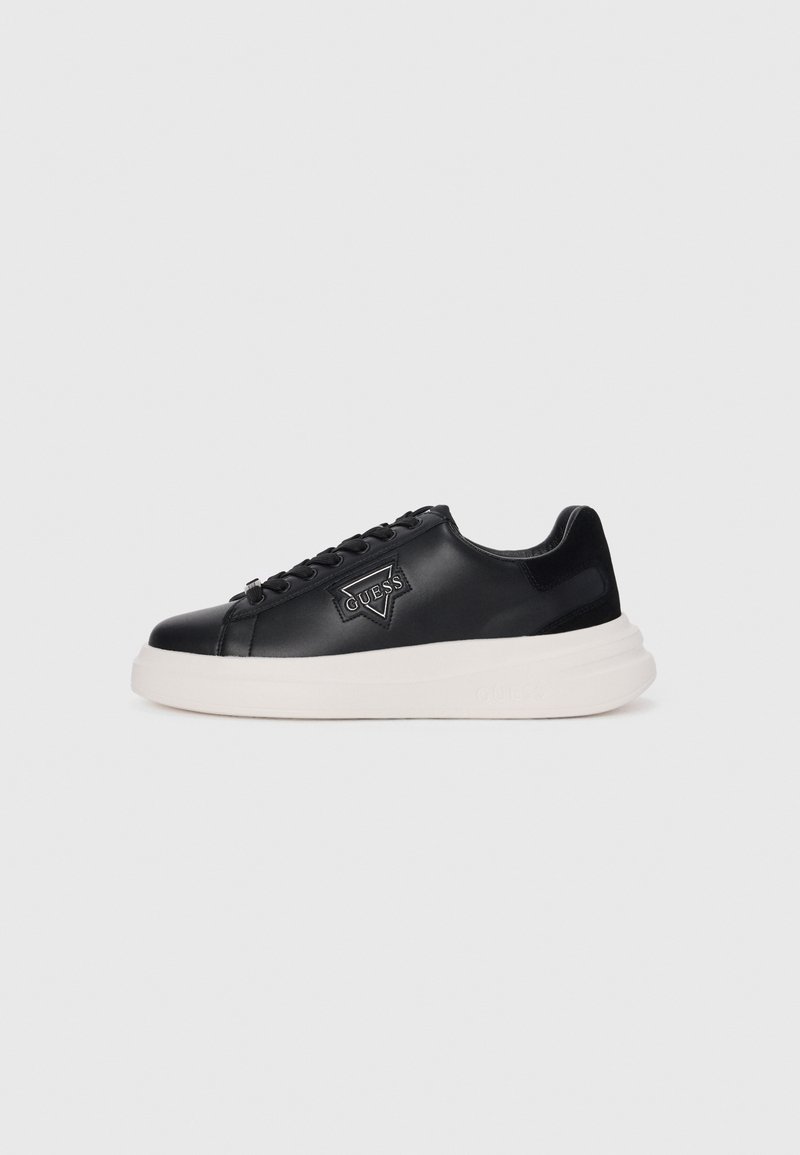 Black leather sneaker with a textured finish, featuring a white platform sole, black laces, and a triangular logo patch on the side.
