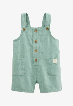Combinaison légère vert clair pour tout-petit avec bretelles, cinq boutons en bois à l'avant, deux poches avant et une petite étiquette "pour les petits".