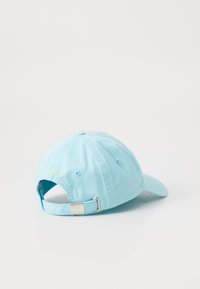 Light blue cotton baseball cap with adjustable strap, embroidered logo on back, curved brim, and six ventilation eyelets.