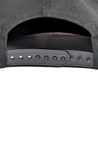 Black adjustable cap with a plastic snap closure featuring evenly spaced holes for size adjustments and a textured fabric finish.