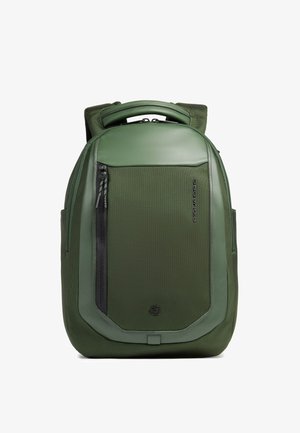 Mochila color verde oliva con asa acolchada, bolsillo frontal con cremallera, tela texturizada y detalles en paneles lisos.