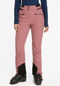 Pantaloni da neve rosa con vestibilità su misura, chiusura con bottone e zip, tasche con zip e dettagli neri alle caviglie. Realizzati in materiale durevole.