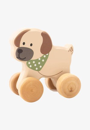 Wooden dog toy with a light beige body, brown ears and nose, green polka-dot scarf, and cylindrical wooden wheels. Smooth texture.