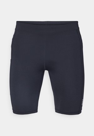 Marineblå shorts laget av stretchmateriale med en tettsittende design. Har glatte sømmer og en liten logo på venstre ben.
