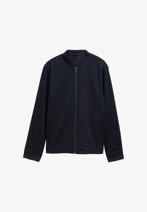 Tumesinine tõmblukkjakk ümarate kraega, pikkade varrukatega, kahe küljetaskuga ja sileda tekstuuriga. Lihtne disain, ilma mustrite või kaunistusteta.