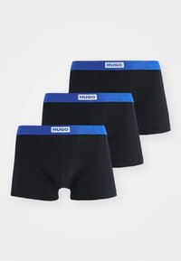 Black boxer briefs in a pack of three, featuring a blue elastic waistband with the "HUGO" logo and soft, stretchy fabric.