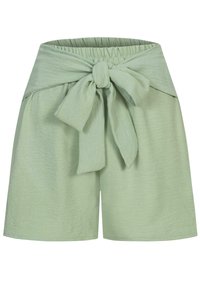 Lys grønne shorts laget av teksturert stoff, med en bred livlinje og en frontknute detalj. Kort lengde med rett snitt.