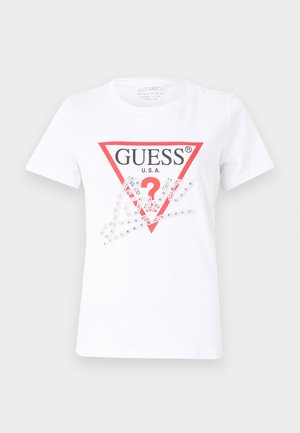 White cotton T-shirt featuring a red triangle logo with "GUESS U.S.A." and a question mark, embellished with clear rhinestones and graphic elements.