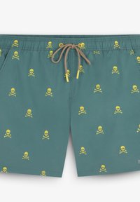 Shorts de bain teal en tissu léger, ornés d'un motif de petites têtes de mort jaunes avec des os croisés, dotés d'une ceinture à cordon de serrage beige.