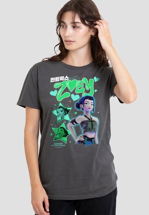 Gray cotton T-shirt featuring a large graphic of a character named ZOEY, surrounded by green hearts and star shapes, with colorful design elements.