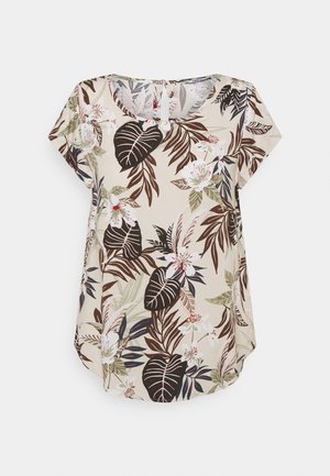Kortärmad blus i beige tyg med ett tropiskt blommönster som har gröna och bruna blad, vita blommor och rosa inslag.
