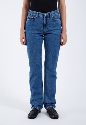 Light blue denim jeans with a straight leg design, five pockets, and subtle stitching details. Front button closure. Textured fabric.