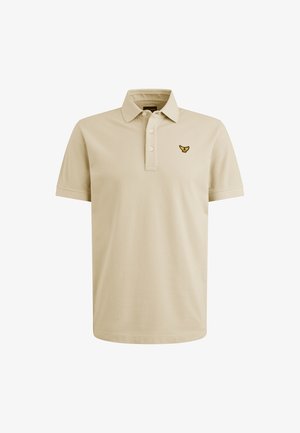 Bež polo majica iz bombaža, z značilnim trima gumbi na vratu in vezenim logotipom na levem prsnem predelu. Mehek material, kratke rokave.