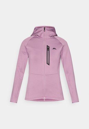 Veste ajustée rose clair avec capuche, poche poitrine zippée verticale et coutures à plat. Texture de tissu douce avec un design sportif.