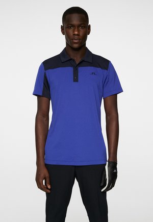 Blue polo shirt with navy accents, short sleeves, and a placket collar. Features logo on the chest and a smooth, lightweight fabric.
