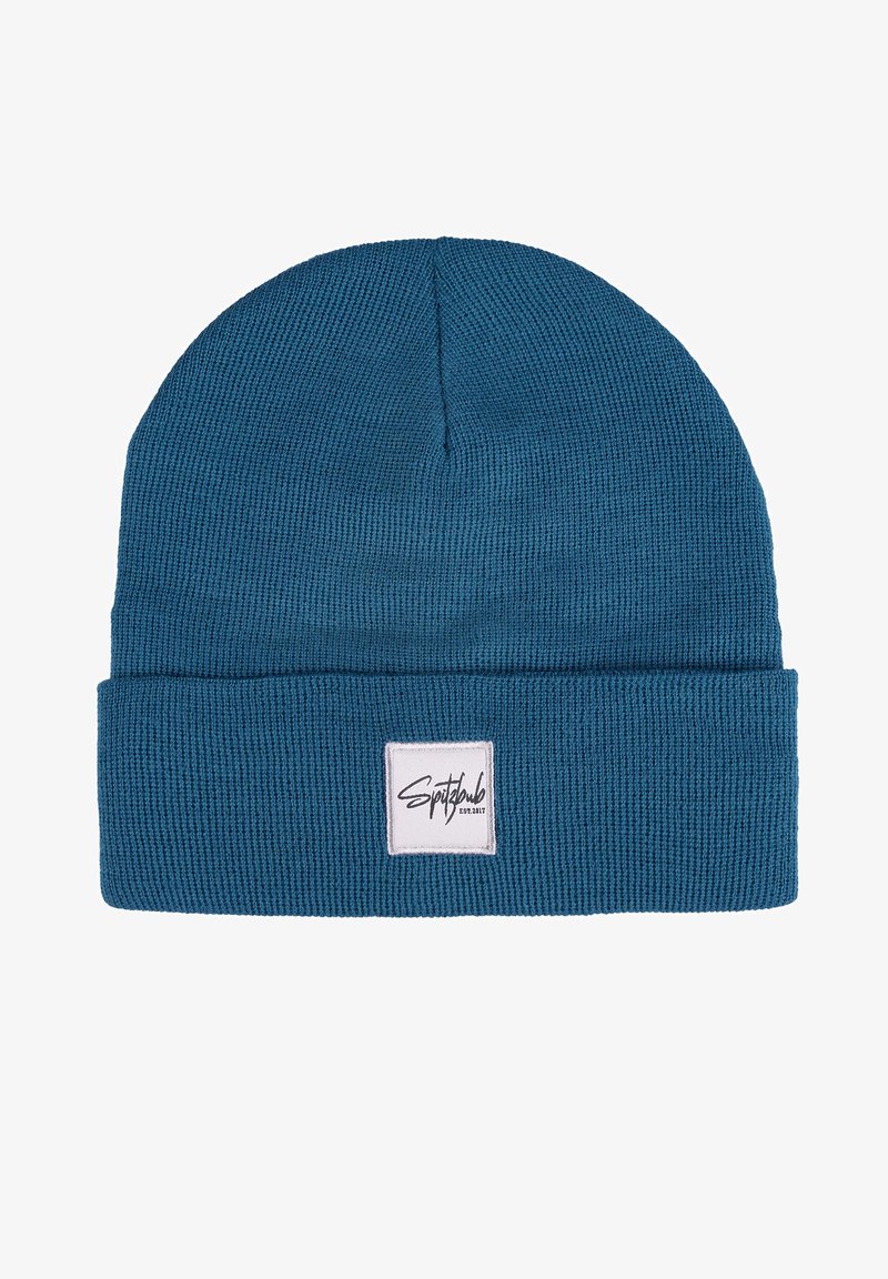Knitted beanie hat in teal blue with a ribbed texture. Features a folded cuff and a square logo patch on the front.