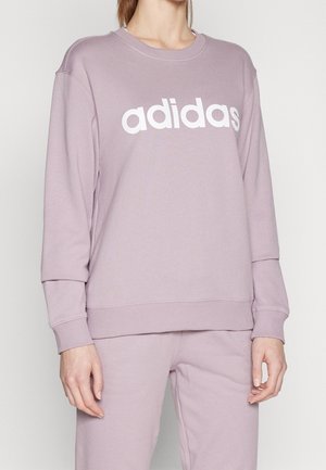 Felpa lilla in morbido tessuto con logo "adidas" bianco sul petto. Polsini e orlo a costine per un look aderente.