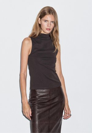 Black sleeveless turtleneck top made of smooth fabric, paired with a fitted brown leather skirt featuring slight sheen and subtle detailing.