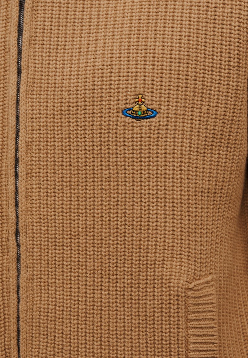 Brown knitted cardigan with a full zipper, featuring a textured pattern and a small, colorful embroidered emblem.