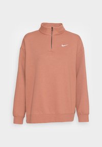 Ljusrosa Nike-pullover sweatshirt med hög krage, kvartsdragkedja och långa ärmar. Har en minimalistisk vit logotyp på bröstet.