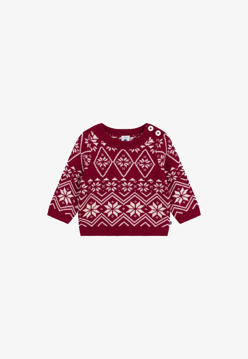 Maglione rosso lavorato a maglia con motivi geometrici color crema, fiocchi di neve e due bottoni sulla spalla per facilitare la vestizione.