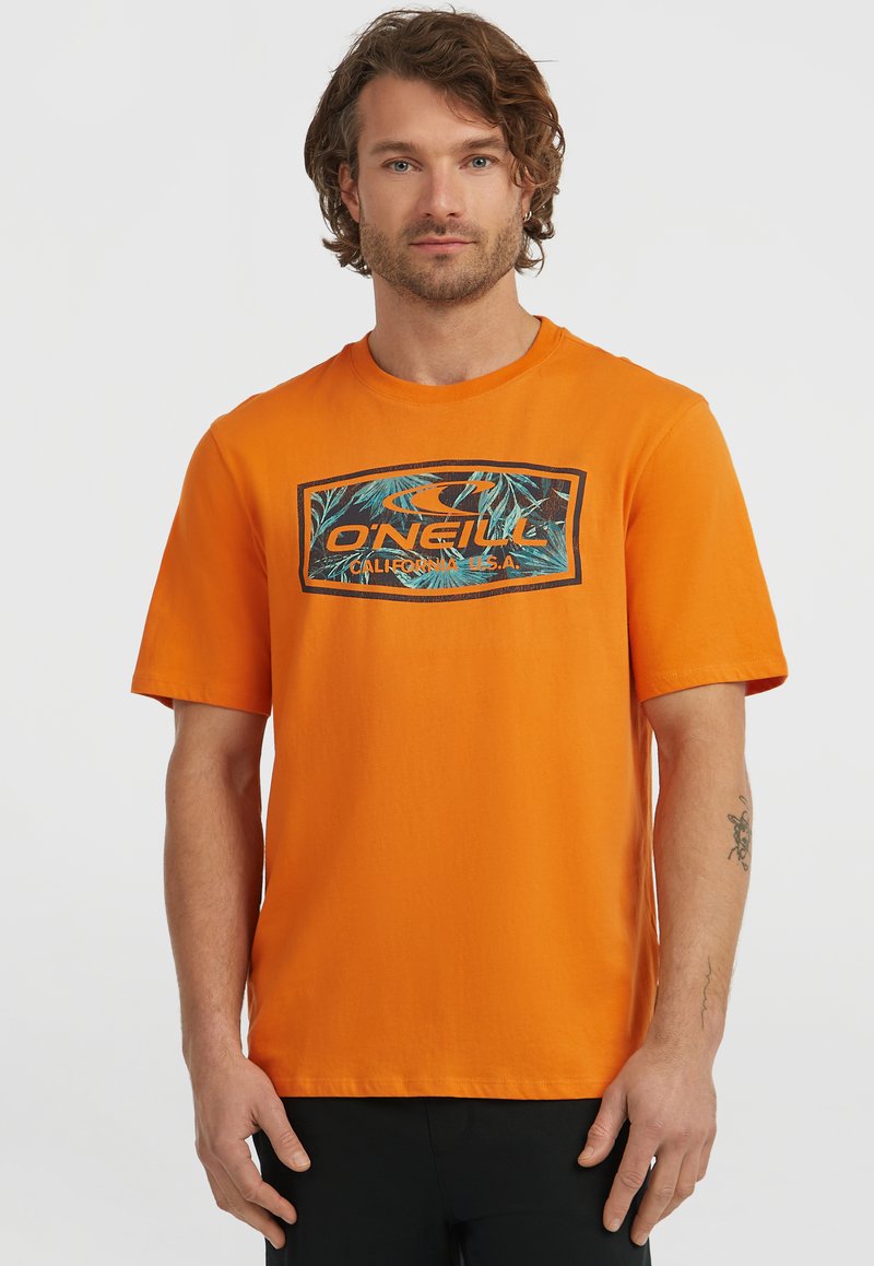 Orange cotton t-shirt with a round neckline and short sleeves, featuring a rectangular graphic of palm leaves and branding in the center.