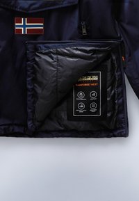 Námořnická vodotěsná bunda s nápletem norské vlajky, zipovými kapsami a podšívkou. Obsahuje označené pokyny pro údržbu a vlastnosti.