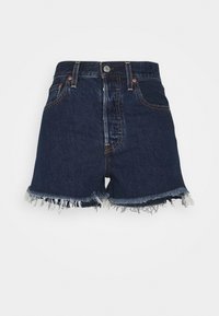 Jeansshorts i mörkblått med hög midja, fransad fåll och kontrasterande sömmar. Har framfickor och knappstängning.