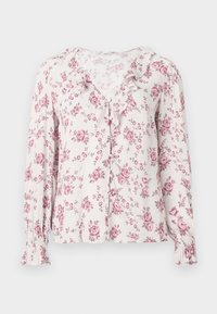 Blusa floreale con maniche lunghe, tessuto morbido, rose rosa su uno sfondo chiaro, dotata di scollatura arricciata e chiusura a bottoni.