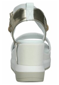 White platform sandals with a textured upper and metallic gold accent on the heel strap. Features a flexible, cushioned sole for comfort.